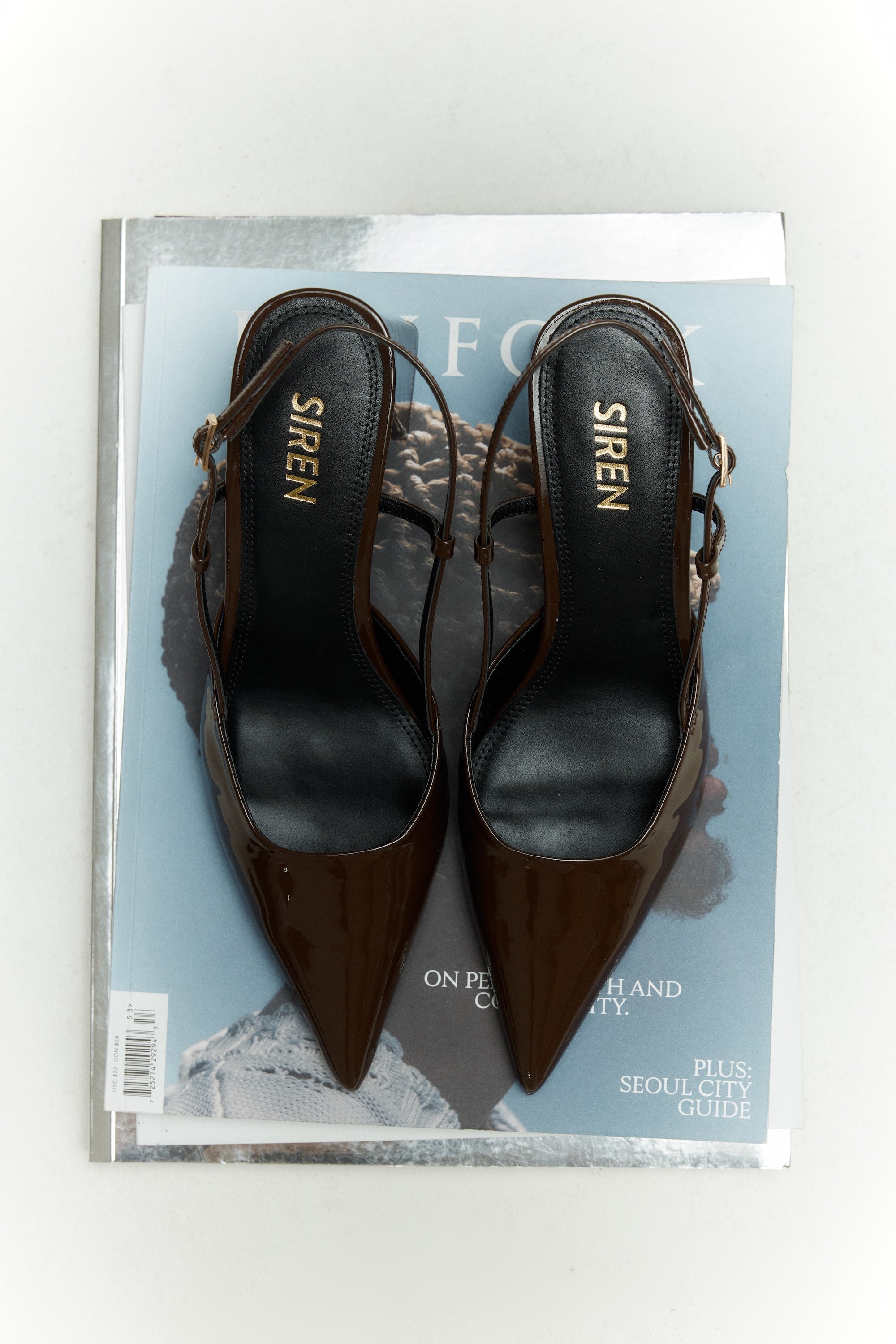 Women's chocolate brown patent leather slingback block heel with buckle fastening and pointed toe