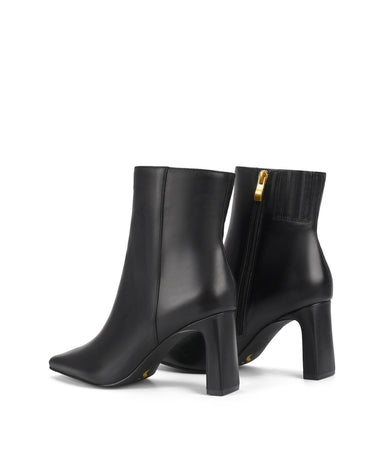 Women's black leather heeled ankle boot with pointed toe and thin block heel