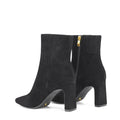 Women's black suede heeled ankle boot with pointed toe and thin block heel