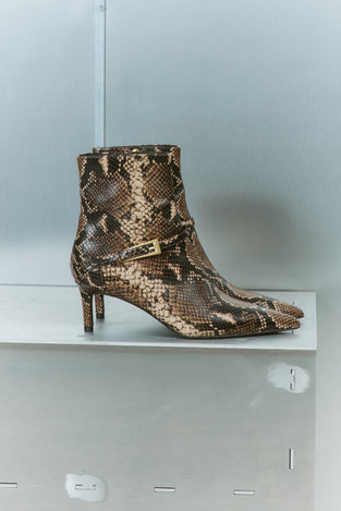 Women's brown snake print leather ankle boot with stiletto heel, pointed toe and gold buckle detailing