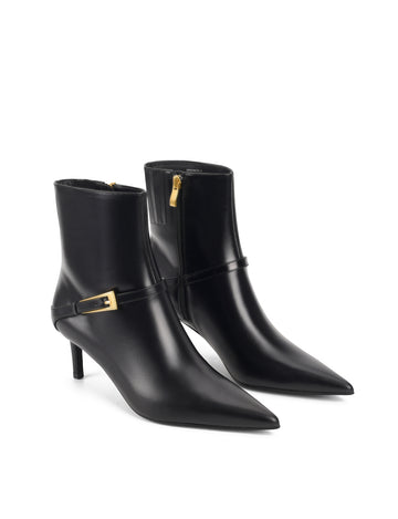 Women's black leather ankle boot with stiletto heel, pointed toe and gold buckle detailing