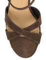 Brown suede sandal with criss-cross straps on a white background