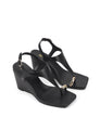 Women's black leather heeled wedge with gold metal toe ring details