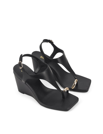 Women's black leather heeled wedge with gold metal toe ring details
