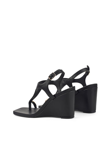 Women's black leather heeled wedge with gold metal toe ring details