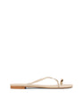 Women's flat strappy sandal with gold metallic toe ring in bone leather