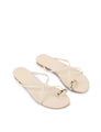 Women's flat strappy sandal with gold metallic toe ring in bone leather