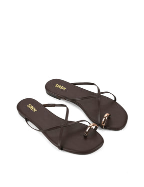 Women's flat strappy sandal with gold metallic toe ring in chocolate brown leather