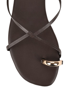 Women's flat strappy sandal with gold metallic toe ring in chocolate brown leather