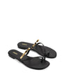 Women's black leather flat slide with gold metallic embellishment, dainty straps and toe ring