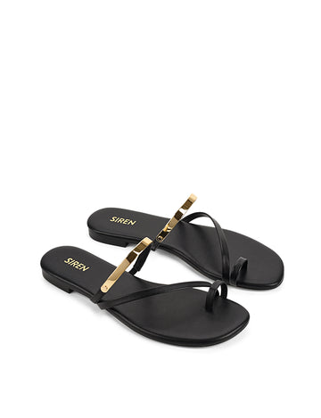 Women's black leather flat slide with gold metallic embellishment, dainty straps and toe ring