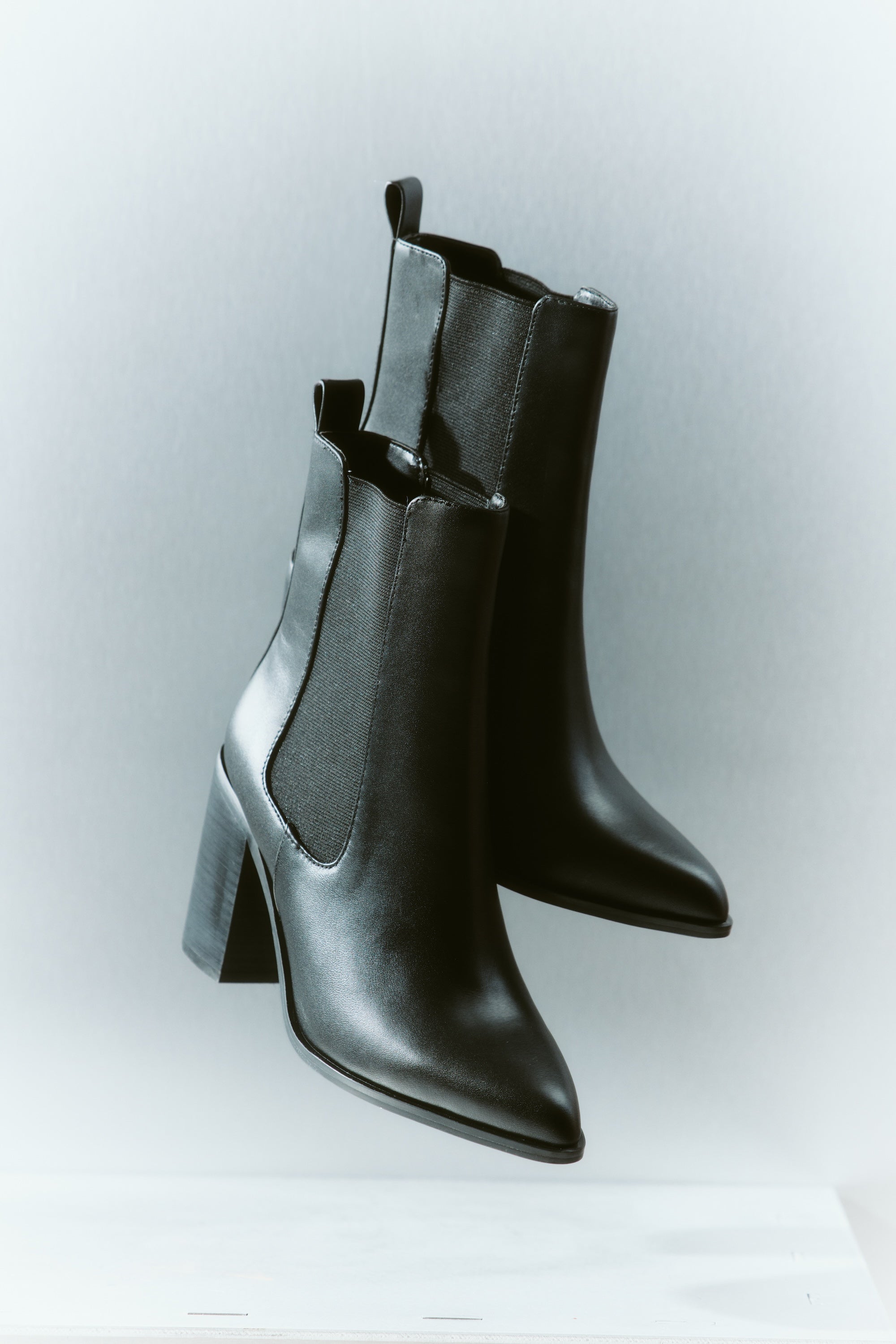 Women's black leather ankle boot with stacked leather block heel, pointed toe and zipper closure
