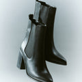 Women's black leather ankle boot with stacked leather block heel, pointed toe and zipper closure