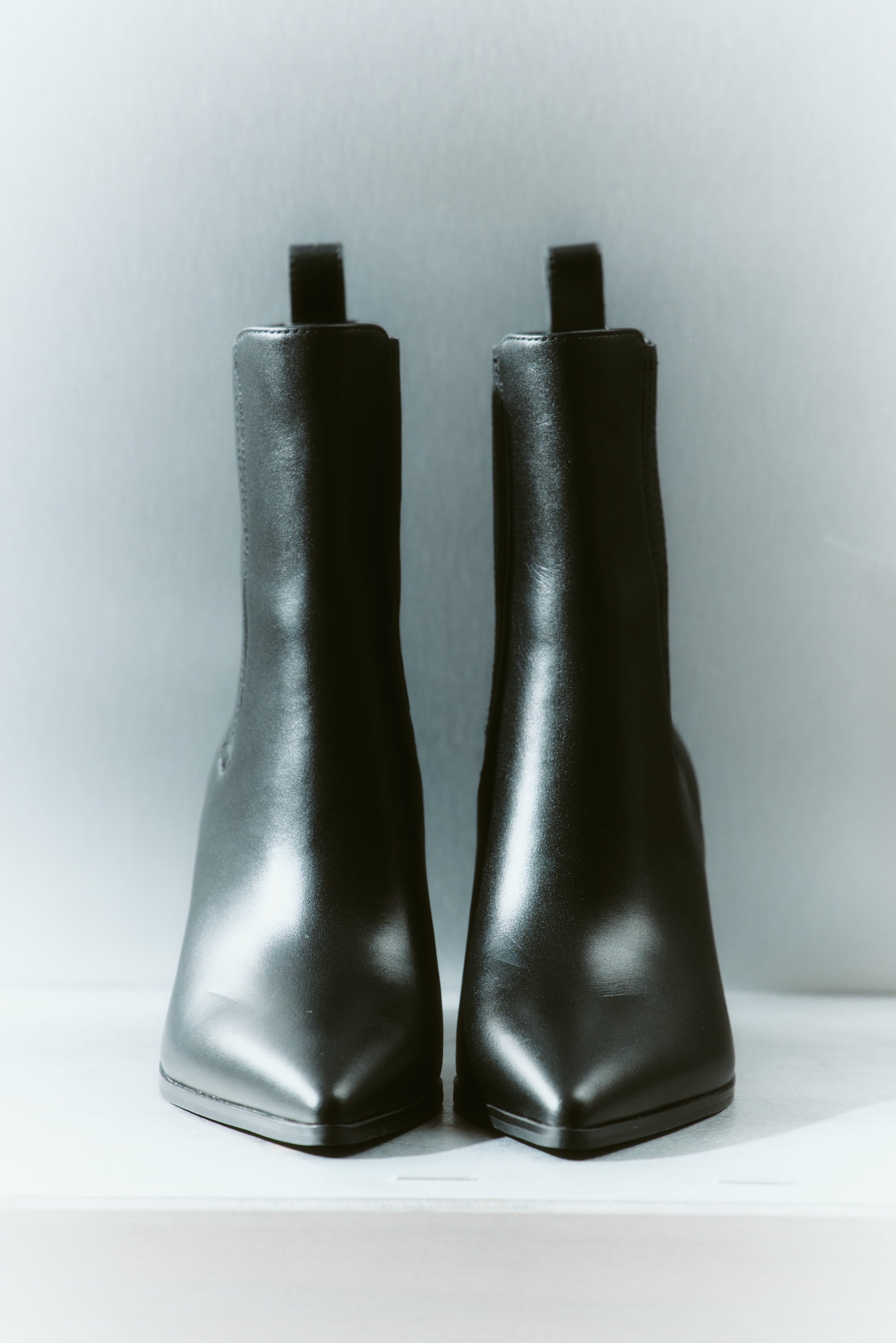 Women's black leather ankle boot with stacked leather block heel, pointed toe and zipper closure