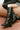 Women's black leather knee high boot with stacked leather block high heel and pointed toe.
