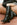 Women's black leather knee high boot with stacked leather block high heel and pointed toe. 