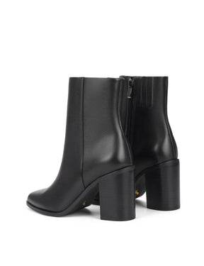 Women's black leather ankle boot with stacked leather block heel, pointed toe and zipper closure