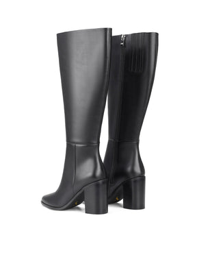 Women's black leather knee high boot with stacked leather block high heel and pointed toe. 