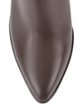 Women's leather knee high boots with stacked leather block high heel and pointed toe and inner zipper.