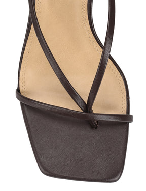 Close-up of a black sandal with thin straps 