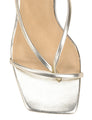 Close-up of a sandal with metallic straps on a white background
