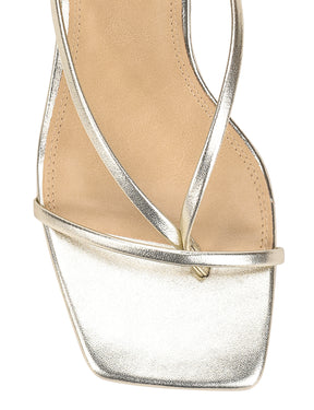 Close-up of a sandal with metallic straps on a white background