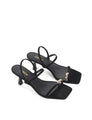 Strappy black sandal with a high heel and gold toe post
