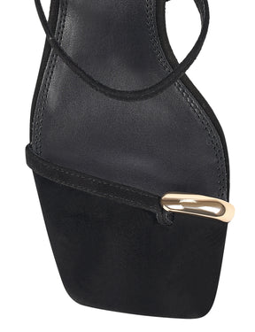 Strappy black sandal with a high heel and gold toe post