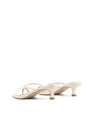 Women's kitten heel strappy sandal with gold metallic toe ring in chalk white leather