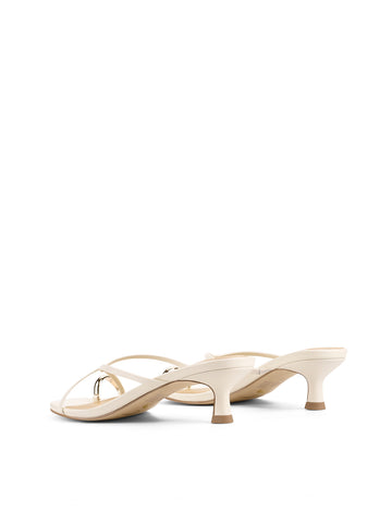 Women's kitten heel strappy sandal with gold metallic toe ring in chalk white leather