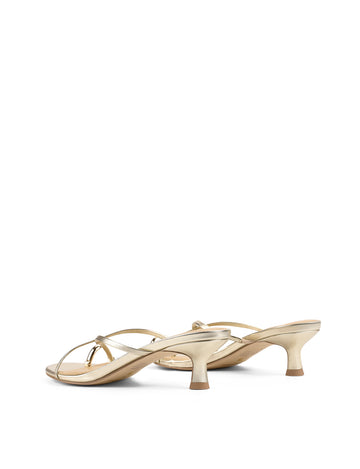 Women's kitten heel strappy sandal with gold metallic toe ring in gold metallic leather