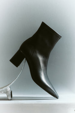 Women's black leather heeled ankle boot with pointed toe