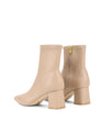 Women's nude stretch leather heeled ankle boot with pointed toe and zip closure
