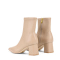 Women's nude stretch leather heeled ankle boot with pointed toe and zip closure