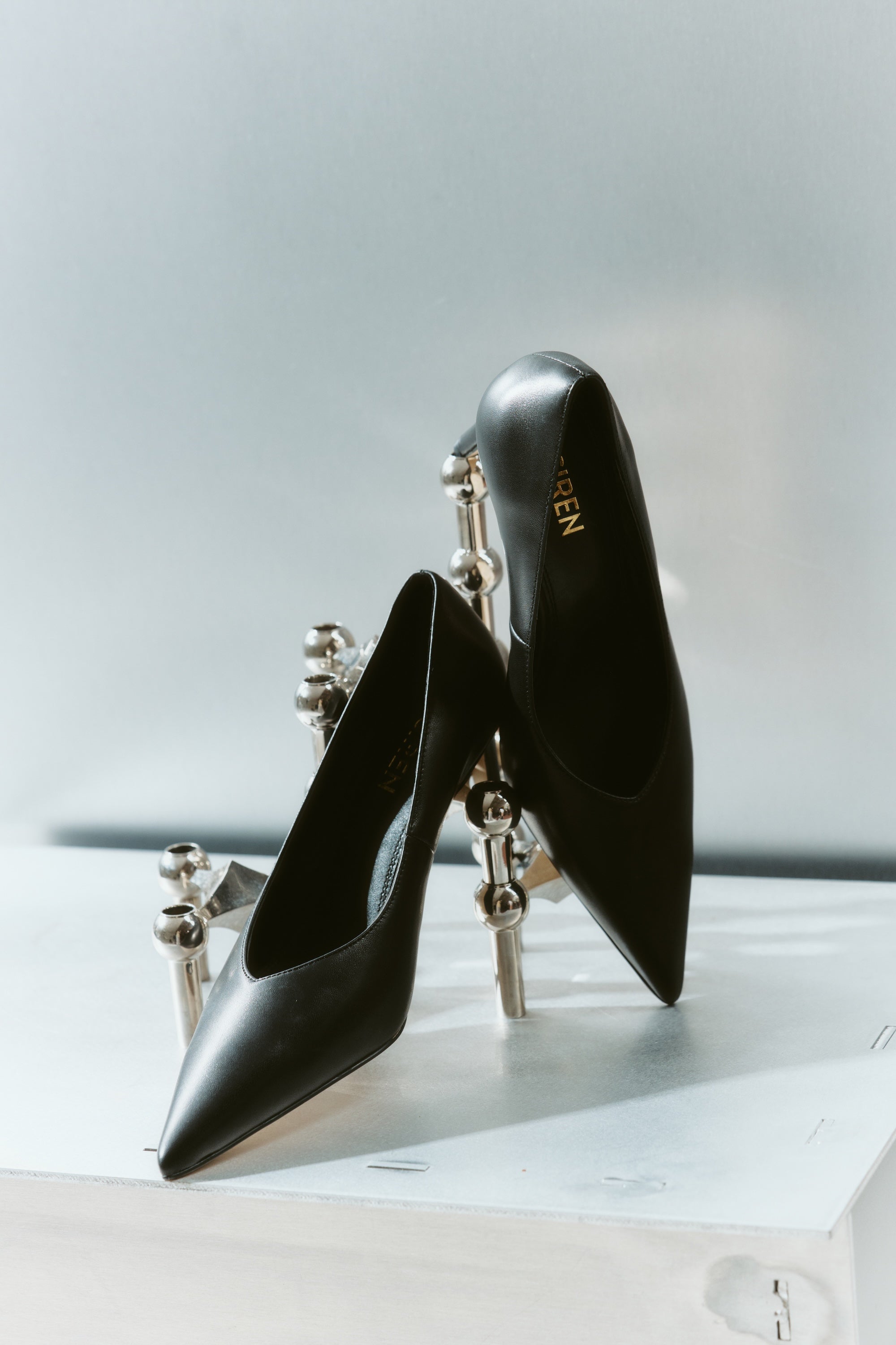 Women's black leather stiletto pumps with pointed toe and v cut throat